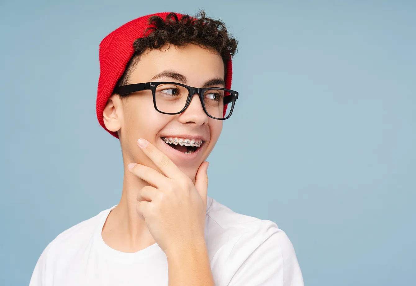 Smiling teenage boy wearing traditional metal braces