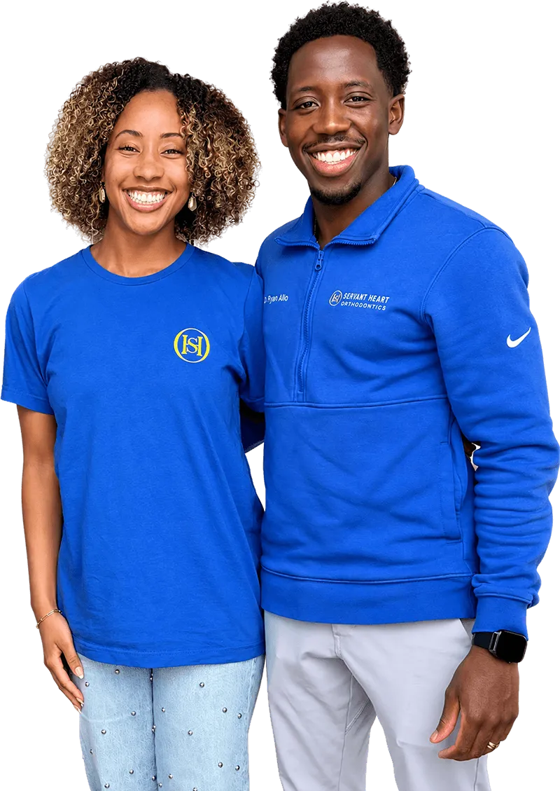 Dr. Ryan Allo and a Servant Heart Orthodontics team member in branded blue apparel