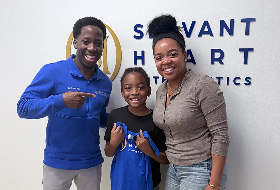 Young orthodontic patient and his mother with Dr. Ryan Allo at Servant Heart Orthodontics in Rowlett, TX